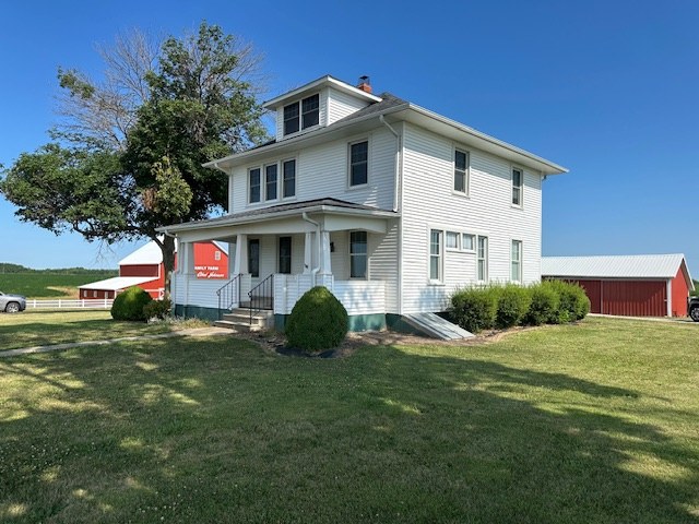 Front elevation of the two-story farmhouse for rent in Louisa County, Iowa