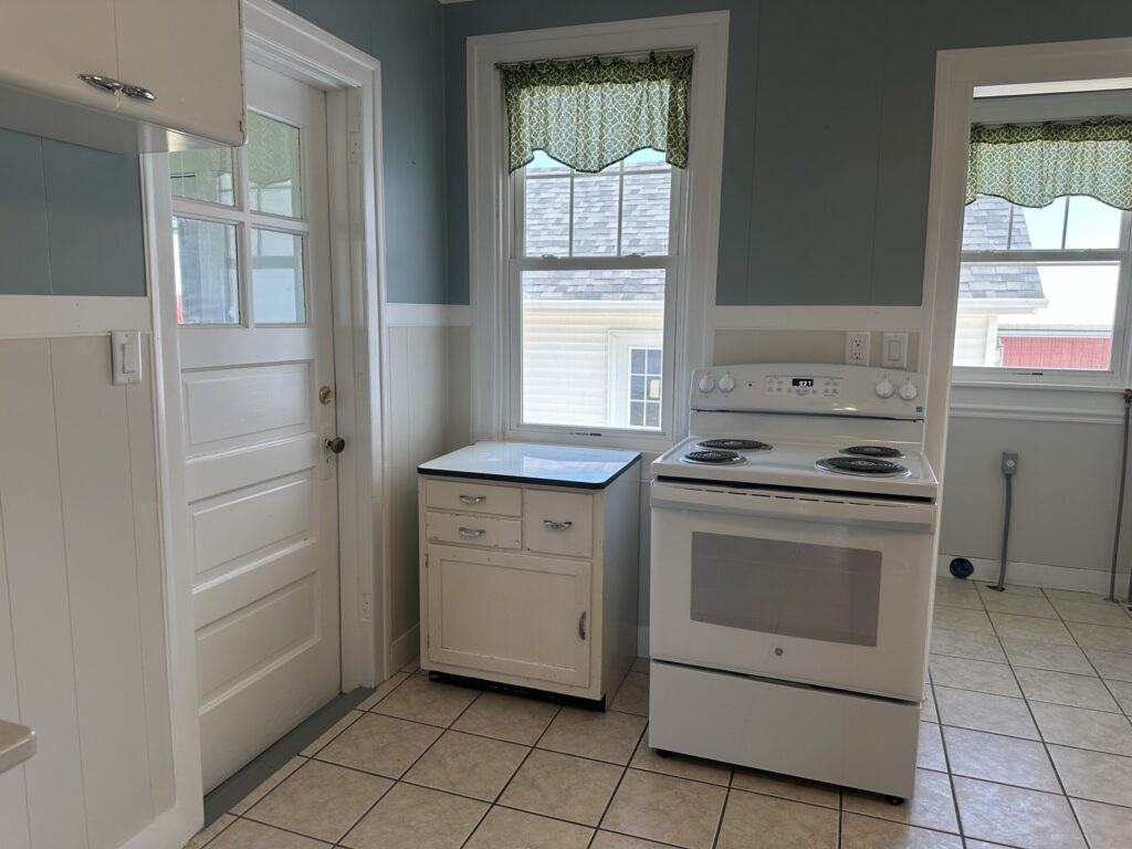 Kitchen with electric range and back door